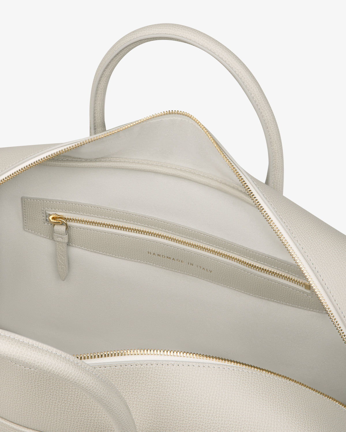 Open Full Grain Leather Briefcase Duffle in beige shows gold zipper pocket and "Handmade in Italy" inside.