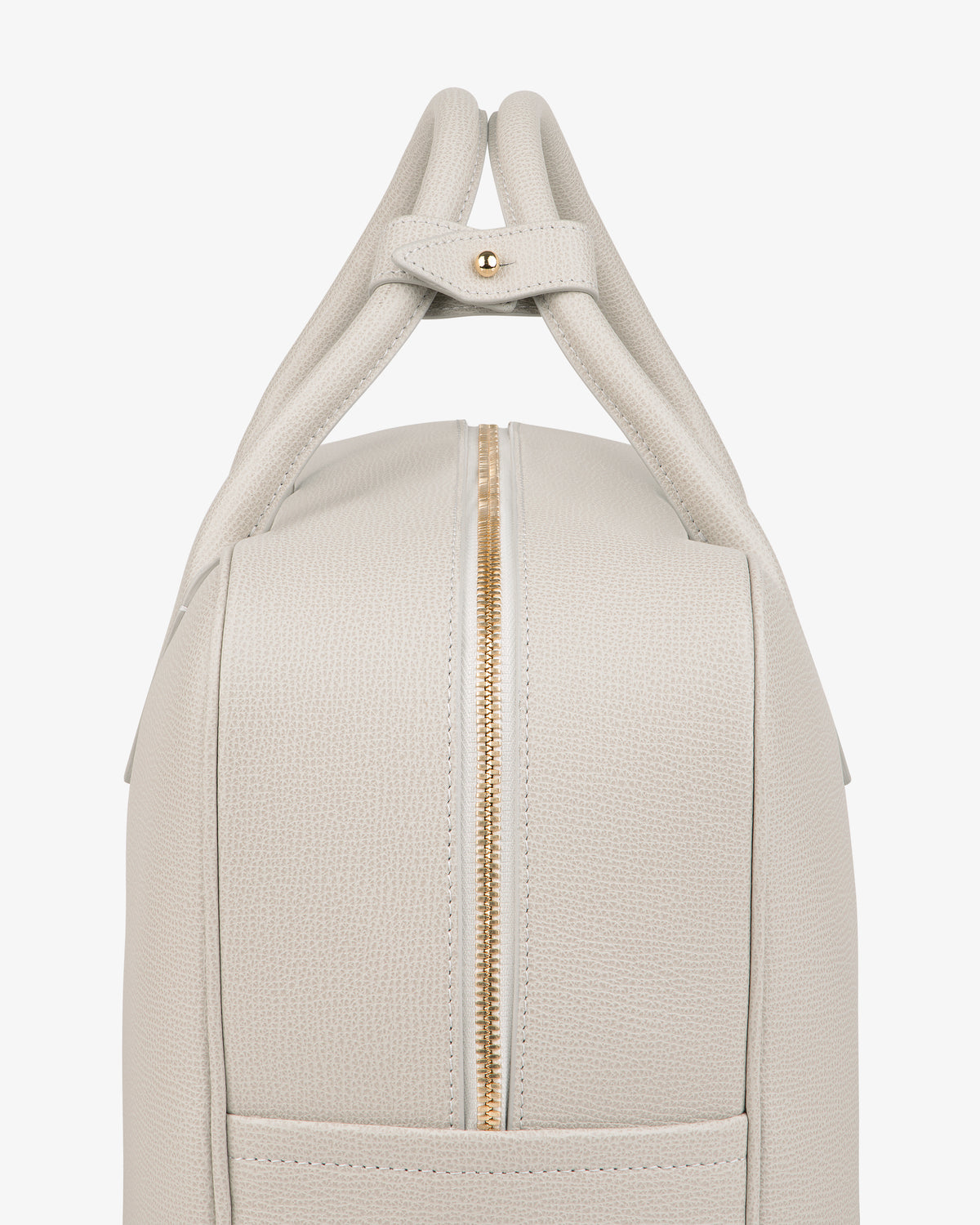 Side view of Full Grain Leather Briefcase Duffle in light beige with gold zipper and two top handles secured together.