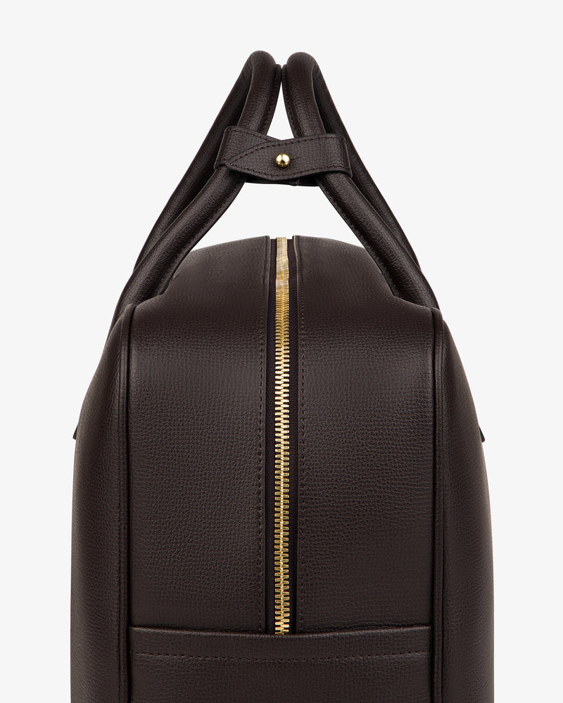 Full Grain Leather Briefcase Duffle in dark brown leather with dual handles and gold zipper, side view on white background.