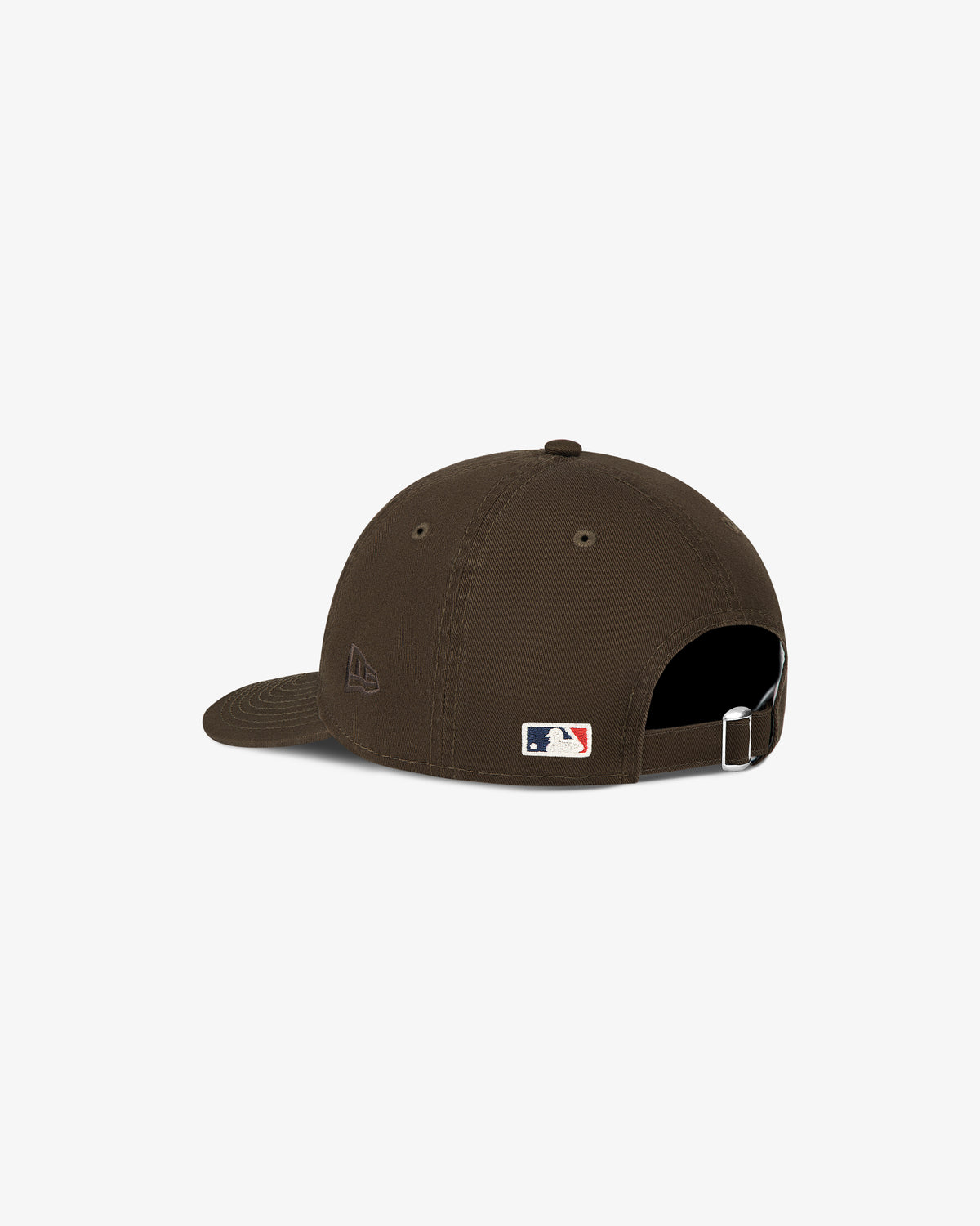 The ALD / New Era Yankees Ballpark Hat is brown, has an adjustable strap, and features an MLB logo above the back opening.