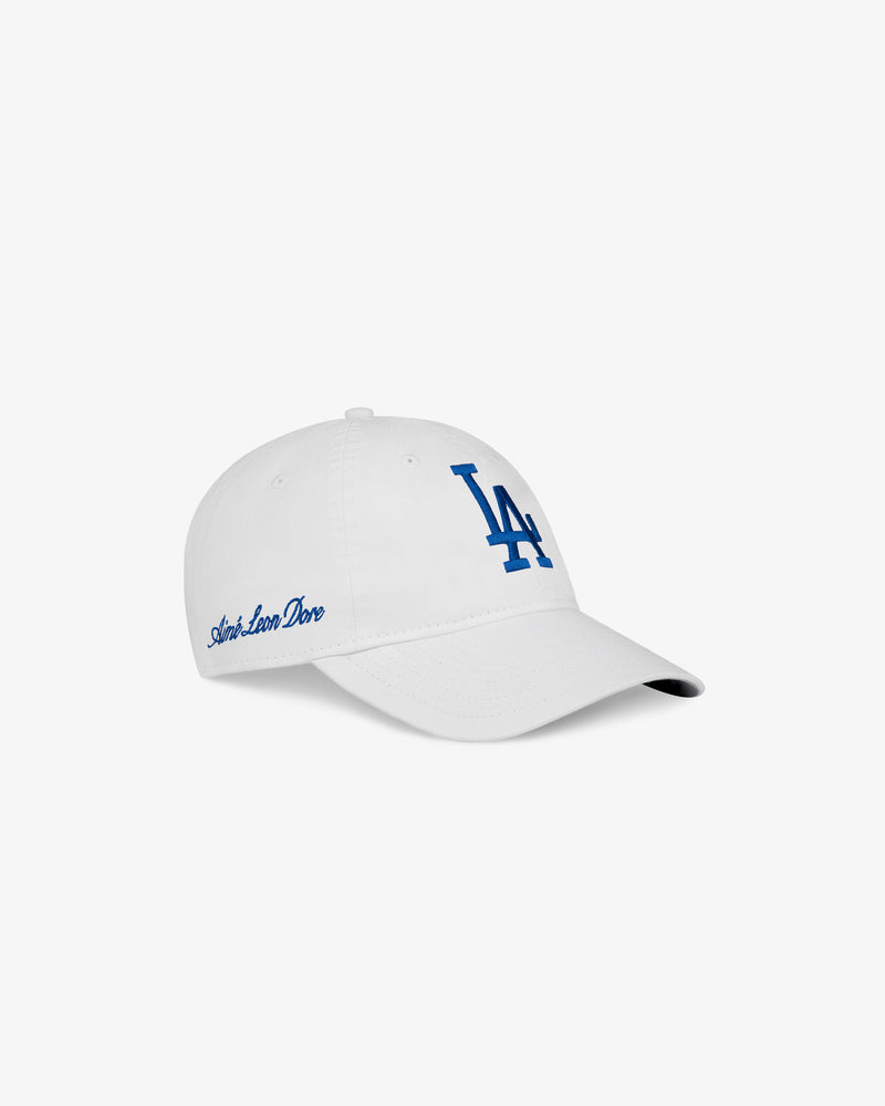 ALD / New Era Dodgers Ballpark Hat: white cap with blue LA logo front and Amor, Loco, Duro script on the side.