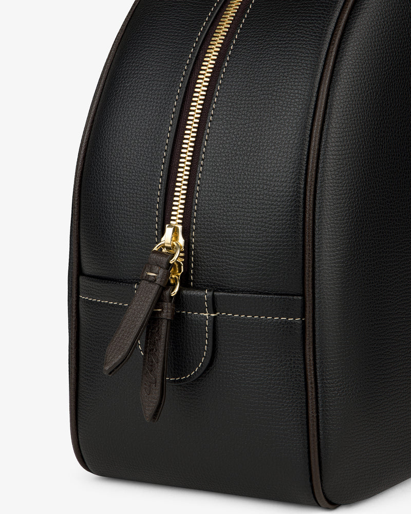 Full Grain Leather Crescent Shoulder Bag in black, features gold zipper, white stitching, and two leather pulls, close up.