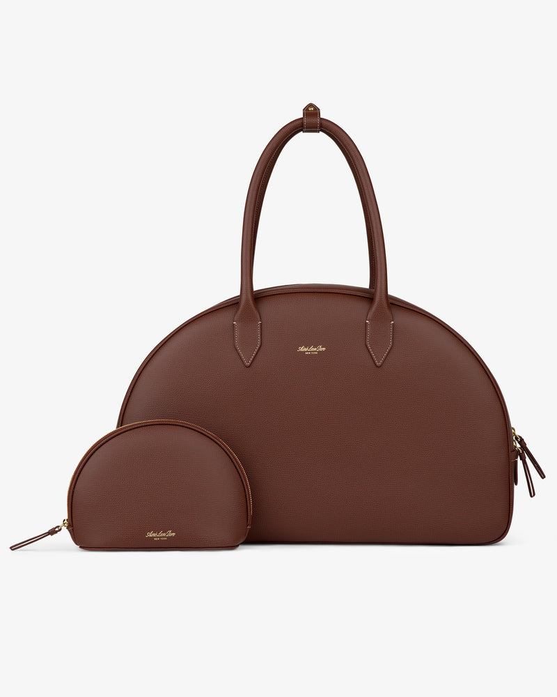 Full Grain Leather Crescent Shoulder Bag with gold zippers and matching pouch, displayed on a white background.