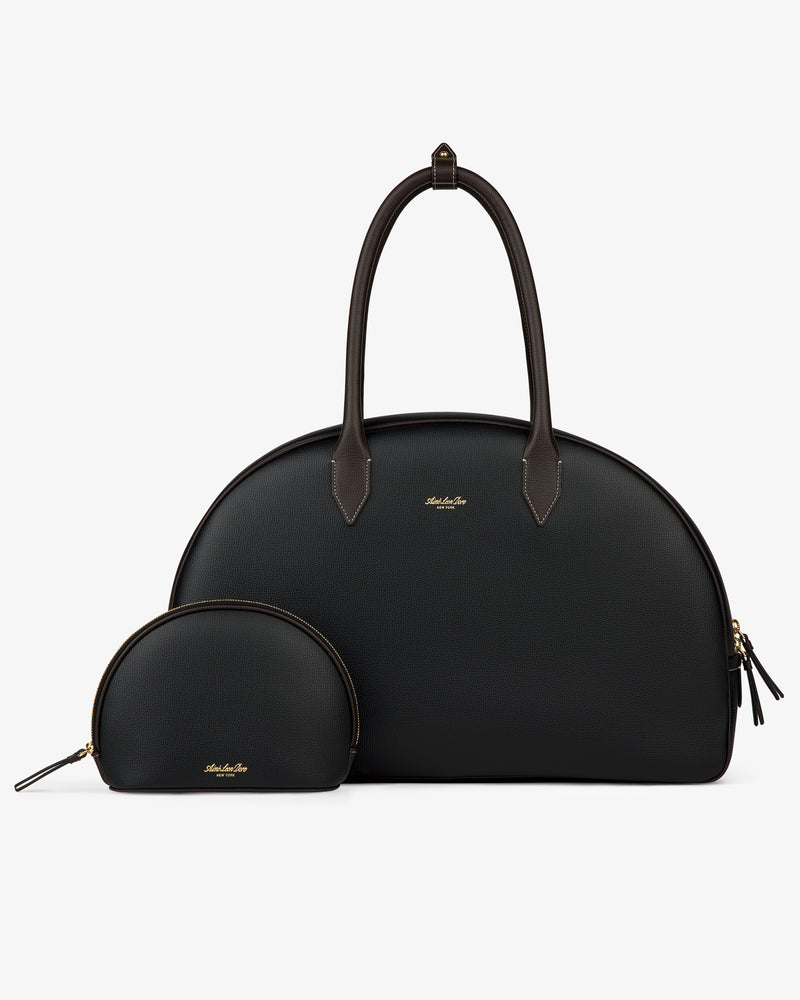 Two Full Grain Leather Crescent Shoulder Bags, large and small, black with brown handles and gold zippers on white.