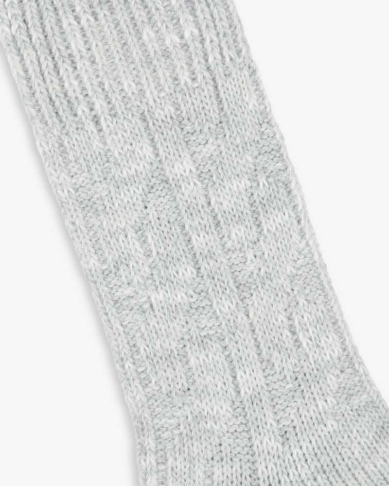 Close-up of light gray Cable Knit Hiking Sock fabric with a textured pattern.
