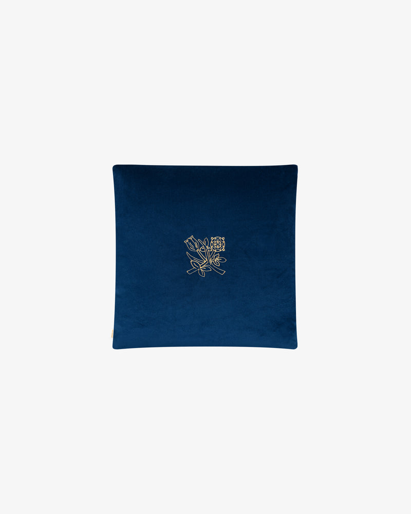 Queens Crest Throw Pillow: Square blue velvet with gold embroidered floral design, shown on plain white background.