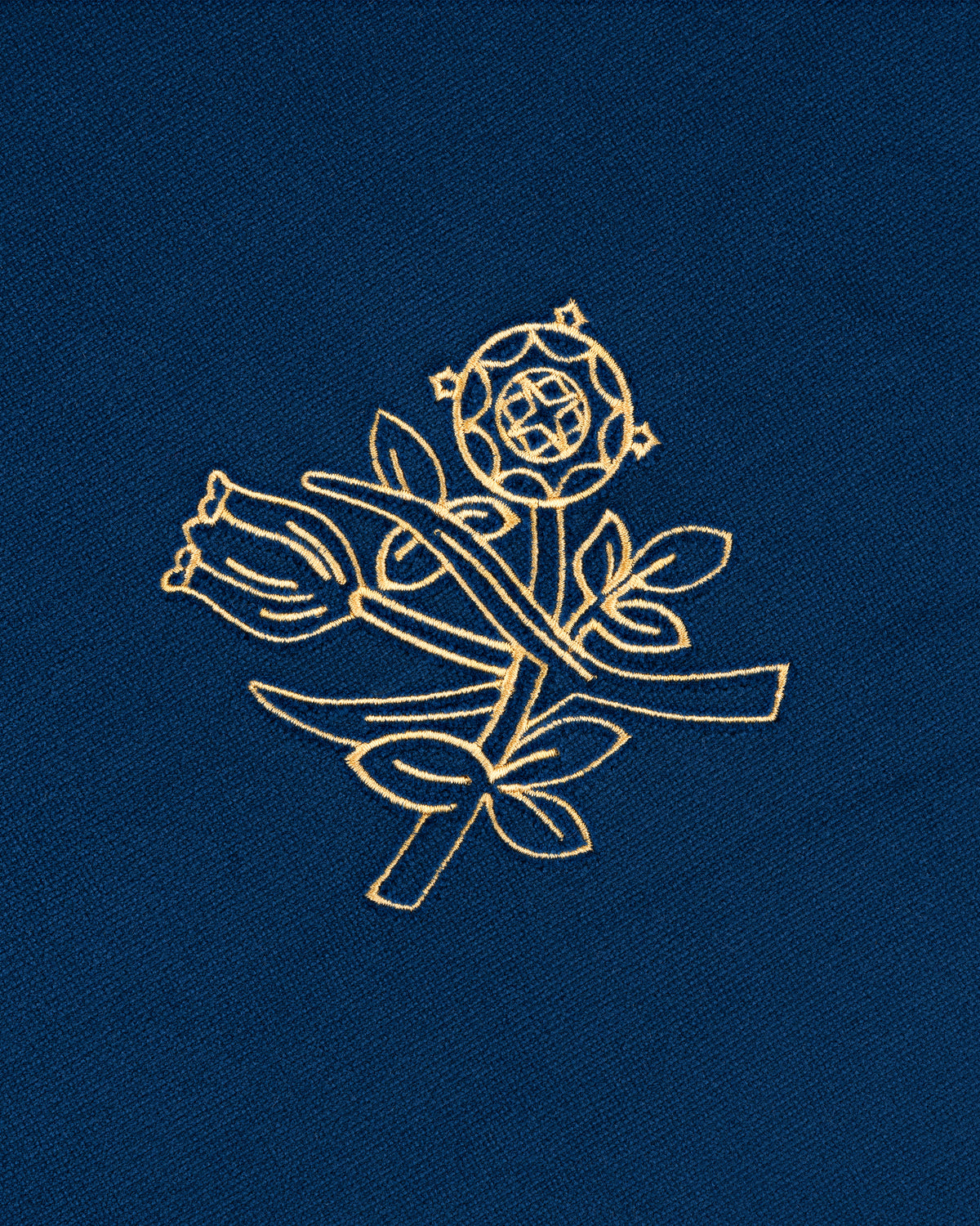 Gold embroidered rose with leaves on blue fabric decorates the Queens Crest Throw Pillow.