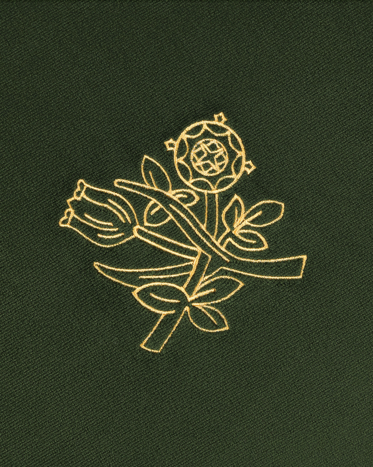 Queens Crest Throw Pillow: Gold embroidered rose and bud with leaves on dark green fabric.