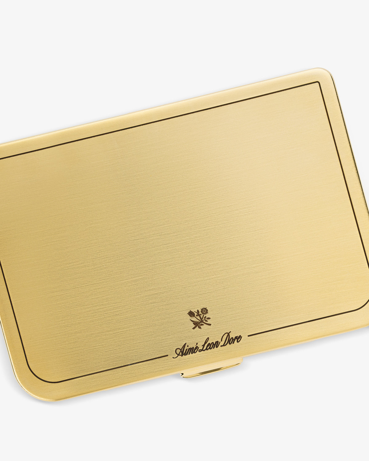 Brass Card Case with a fine border, floral emblem, and Aime Leon Dore inscribed near the bottom center.