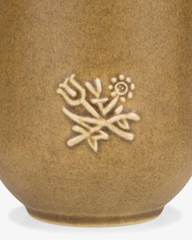 The Queens Crest Artisanal Vase features embossed tulip and daisy flowers on brown textured ceramic.