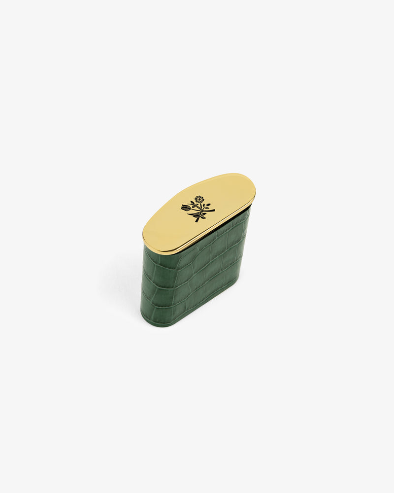 Queens Crest Croc Portable Ashtray: small green textured case with gold oval lid, black rose design, white background.