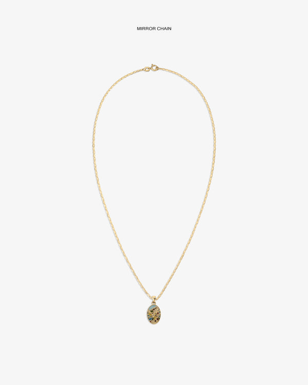14Kt Gold Molina Pendant: oval design with intricate dark detail on white, hung on a gold chain necklace.