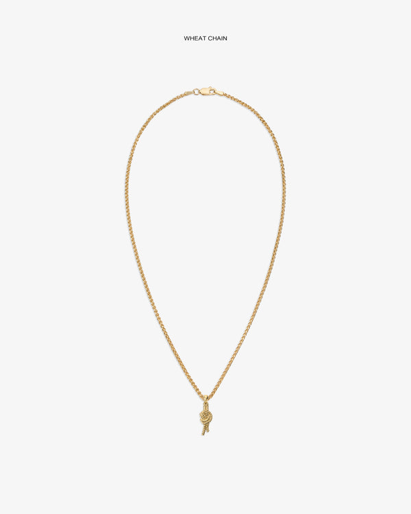 14Kt Gold Nautical Knot Pendant on a wheat chain with small charm, shown against a white background.