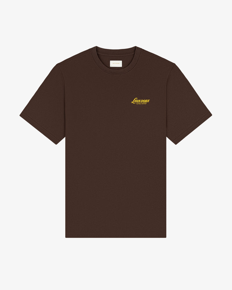 Brown Leon Dore Tee with a small yellow Legends logo on the left chest, shown on a white background.