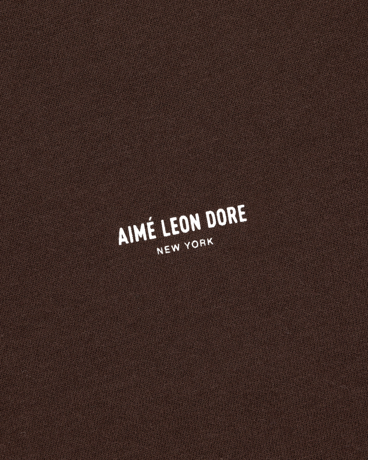 Brown Micro Logo Tee featuring white AIMÉ LEON DORE NEW YORK text printed at the center.