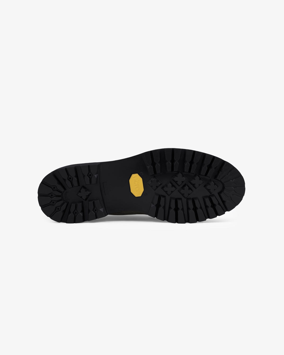 Suede Lug Sole Derby with a black rugged sole, deep treads, and yellow hexagonal logo on a white background.
