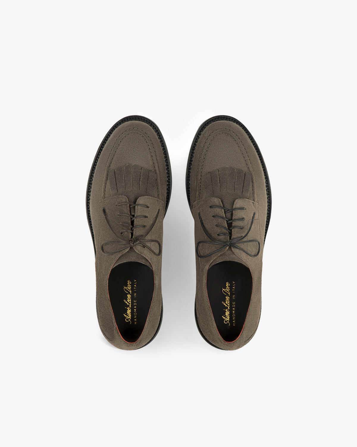 Top view of Suede Lug Sole Derby in taupe suede with black soles, shown on a white background.