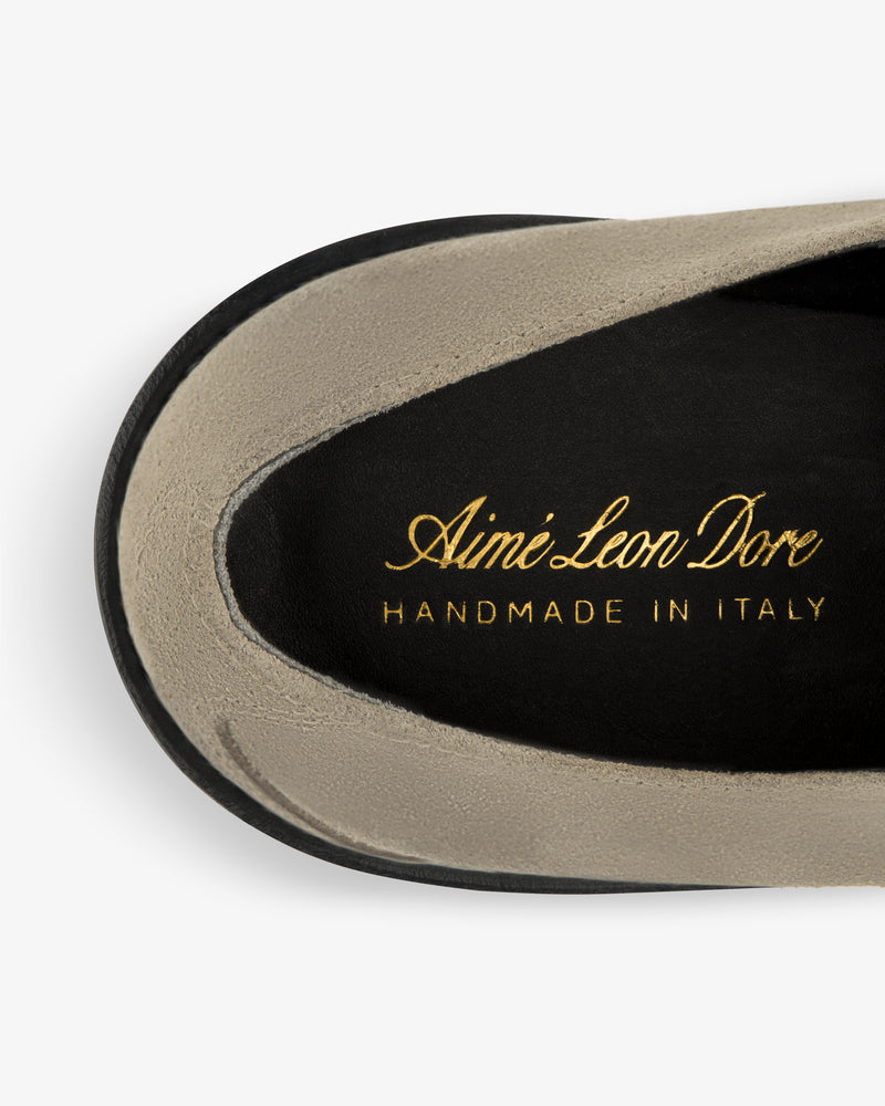 Close-up of a Suede Lug Sole Derby insole with Aimé Leon Dore HANDMADE IN ITALY in gold on black.