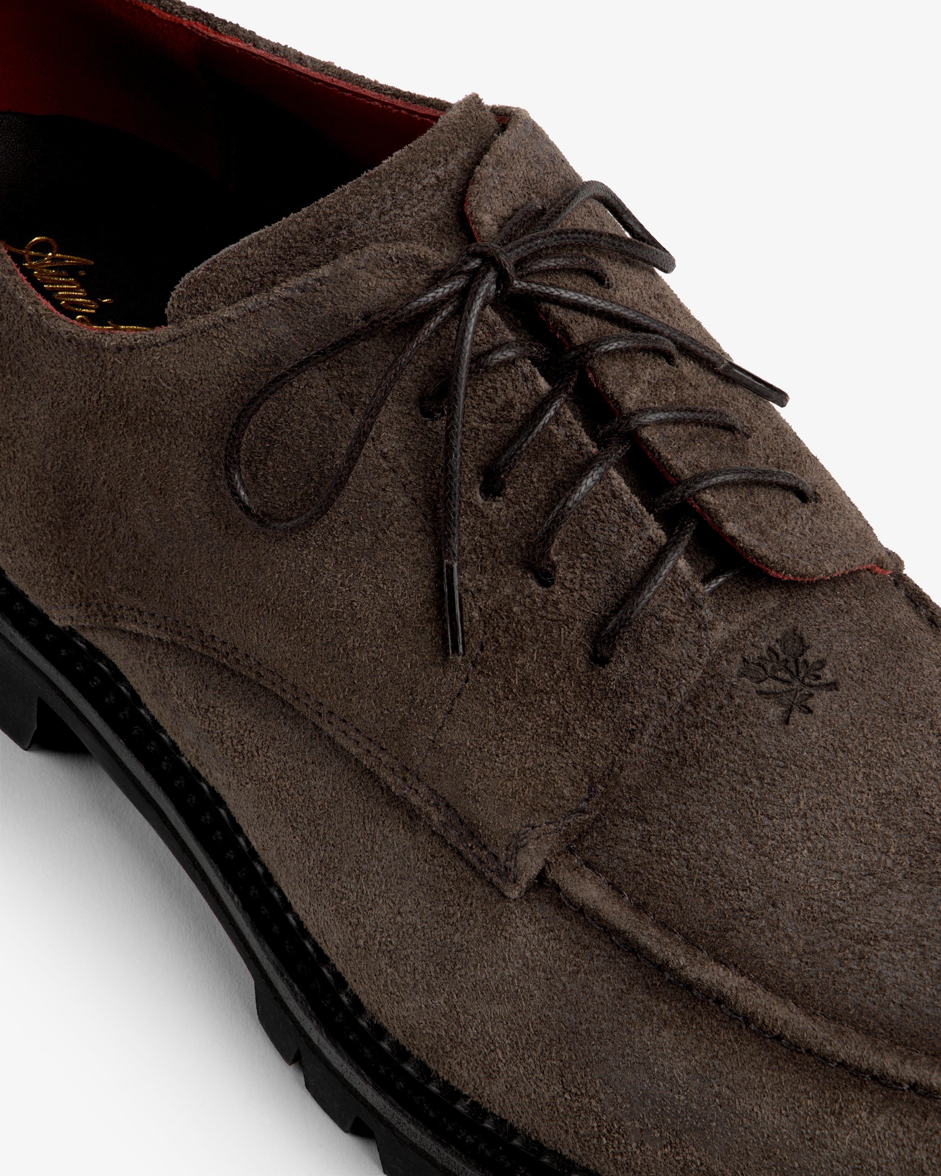 Suede Lug Sole Derby in brown suede with a thick black lug sole and lace-up closure.