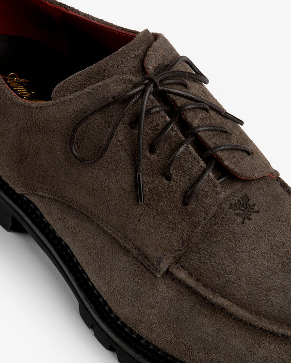 Suede Lug Sole Derby in brown suede with a thick black lug sole and lace-up closure.