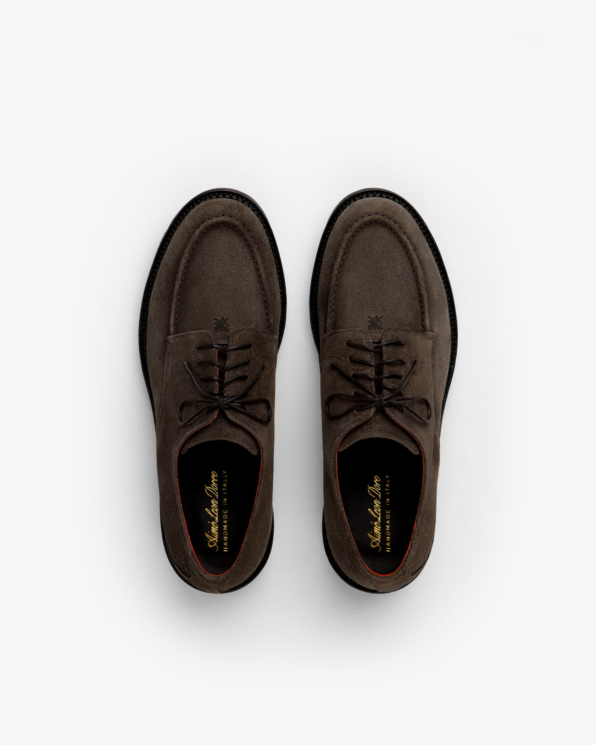 A pair of brown Suede Lug Sole Derby shoes with black lug soles viewed from above.
