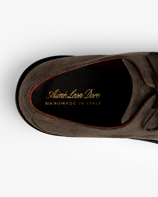 Top-down view of a grey Suede Lug Sole Derby showing the black insole with gold Aimé Leon Dore text.