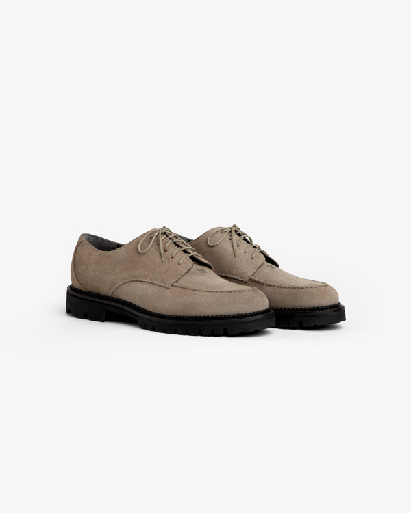 Suede Lug Sole Derby shoes in taupe suede with lace-up closures and chunky black lug soles.
