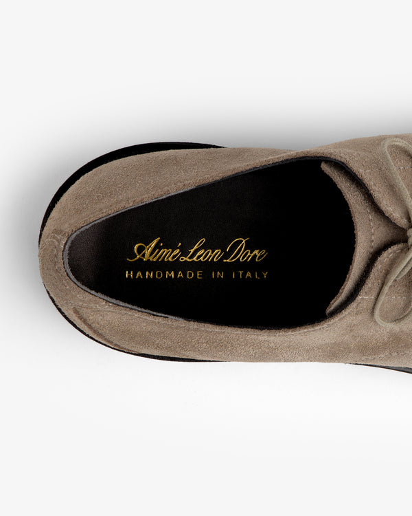 Top-down view of a tan suede Suede Lug Sole Derby with gold branding printed on the black leather insole.