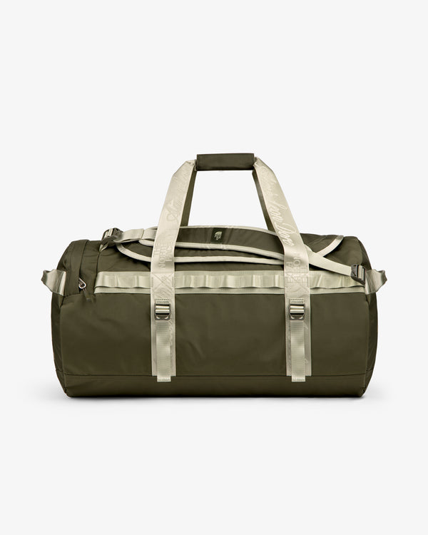 ALD / The North Face Base Camp Duffel in olive green with beige handles, pictured on a plain white background.