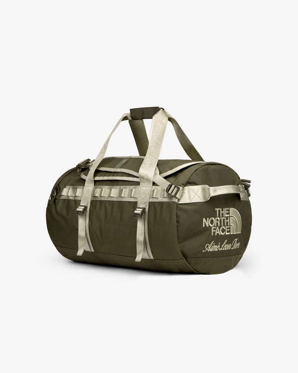 Olive green ALD/The North Face Base Camp Duffel with beige straps and logo, shown on a white background.
