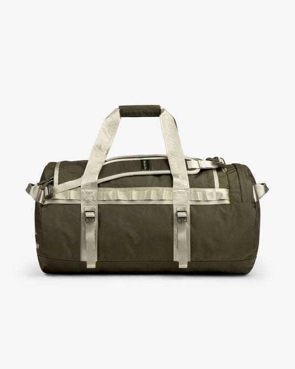 ALD / The North Face Base Camp Duffel in olive green with beige handles and straps, shown on a white background.