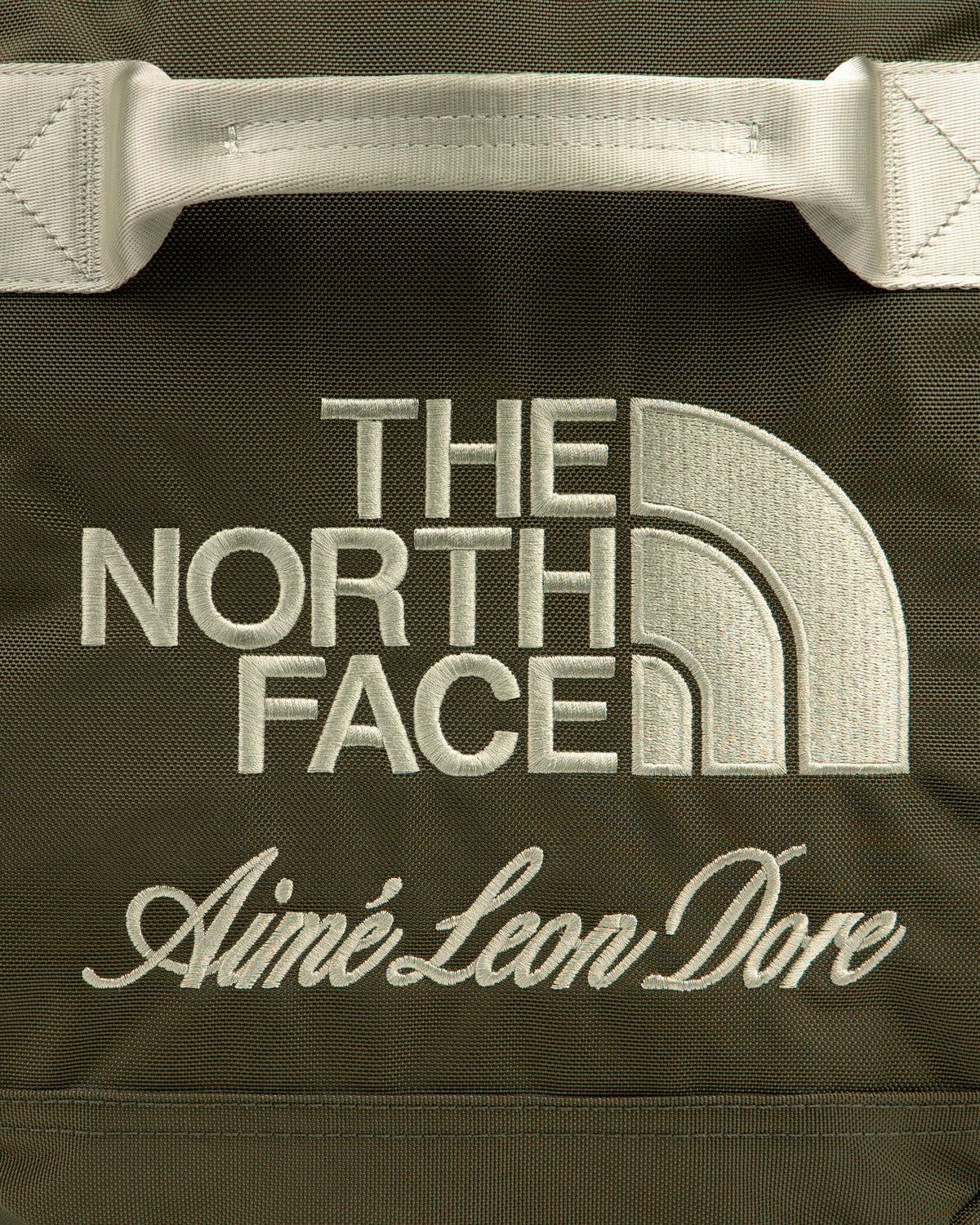 Olive green ALD / The North Face Base Camp Duffel with cream embroidered brand logos.