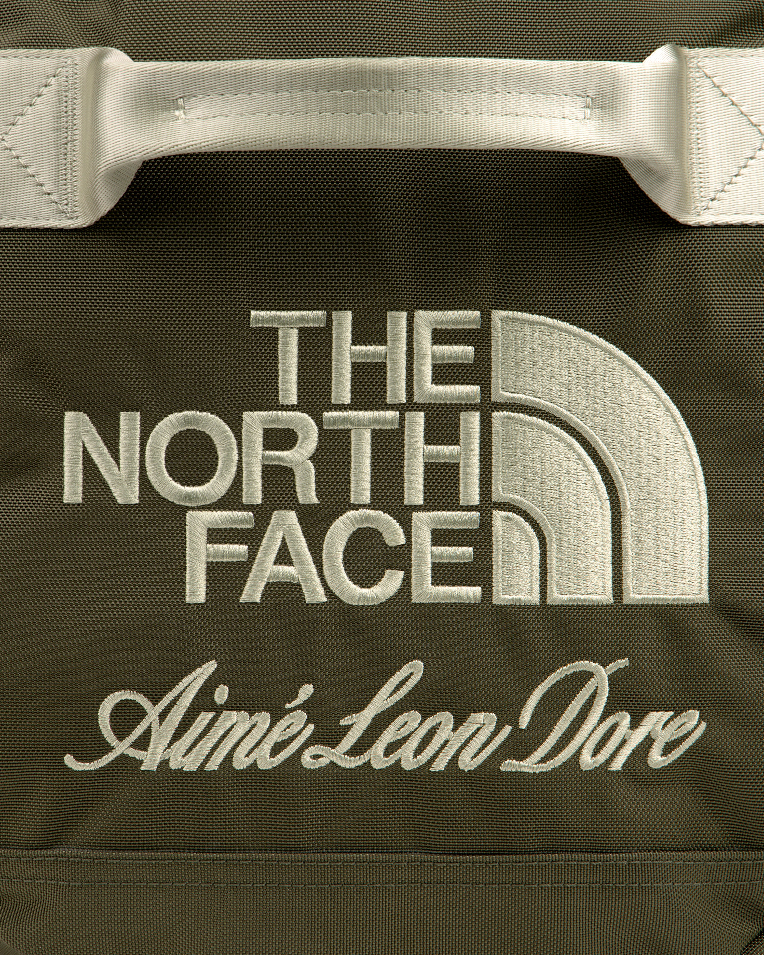 Olive green ALD / The North Face Base Camp Duffel with cream embroidered brand logos.