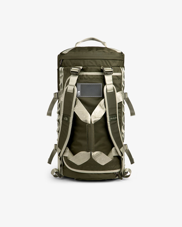 ALD / The North Face Base Camp Duffel in olive green and beige, shown from the back with straps and mesh panel.
