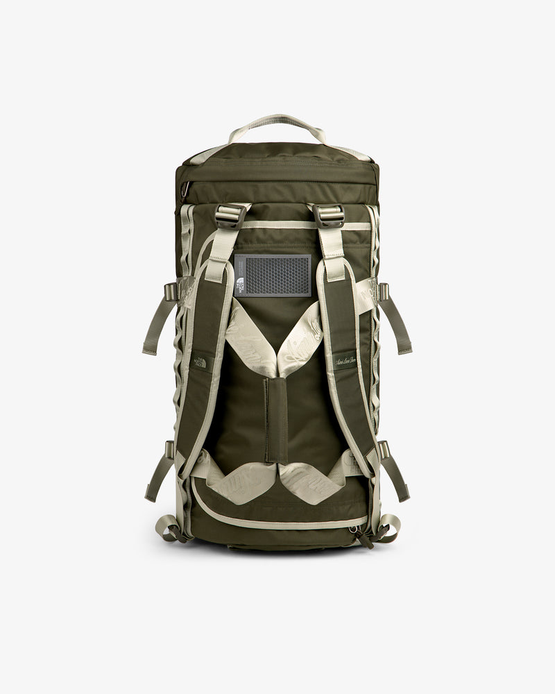 ALD / The North Face Base Camp Duffel in olive green and beige, shown from the back with straps and mesh panel.