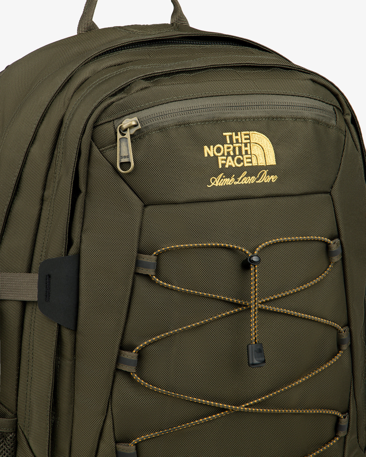Olive green ALD / The North Face Borealis Backpack with yellow logo, front zip pocket, and yellow bungee cords.
