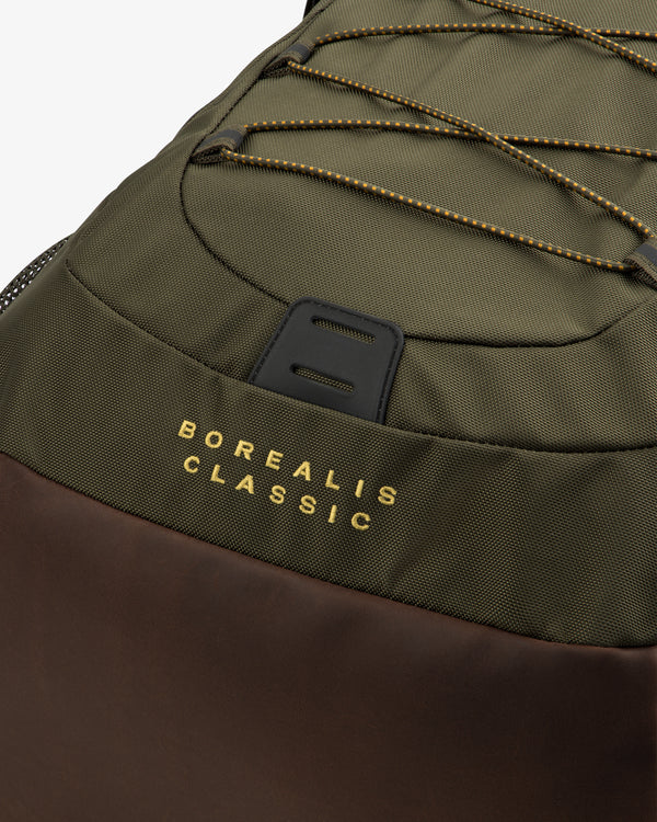 Close-up of the ALD / The North Face Borealis Backpack in olive and brown with yellow branding on the fabric.