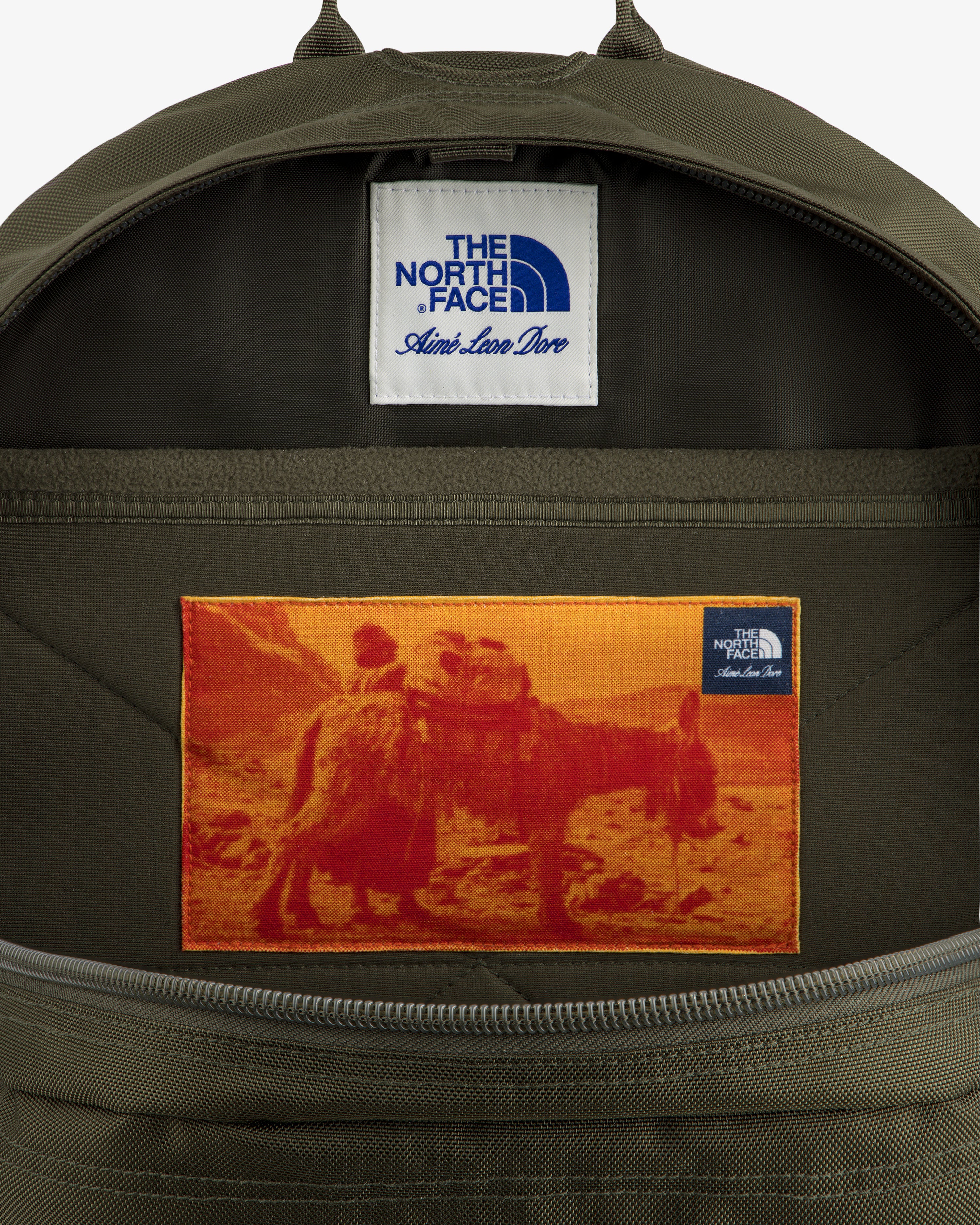 A green ALD / The North Face Borealis Backpack features a camel rider patch and visible logo labels.