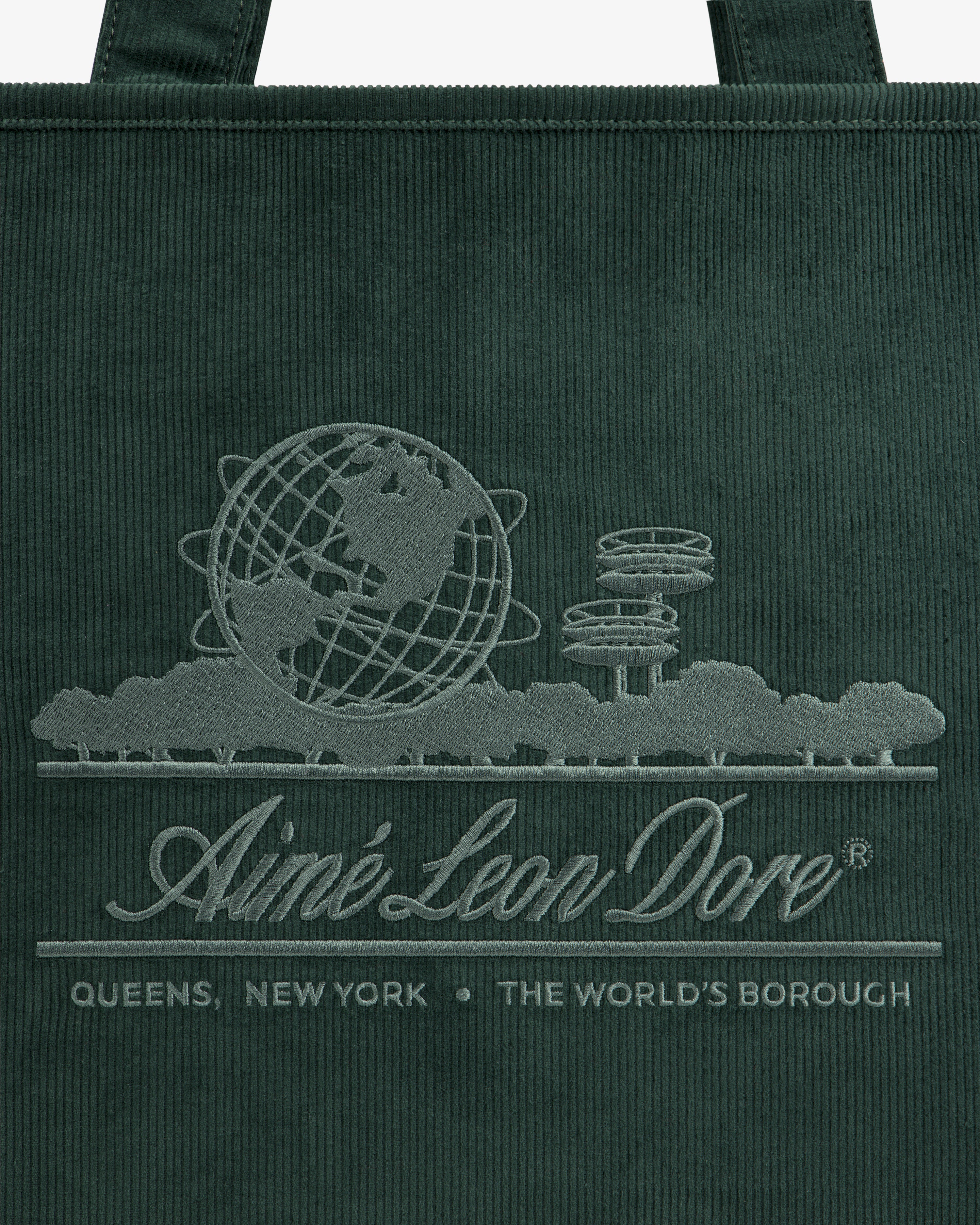 Large Corduroy Unisphere Tote Bag in dark green, embroidered with the Unisphere globe, park trees, and brand text.