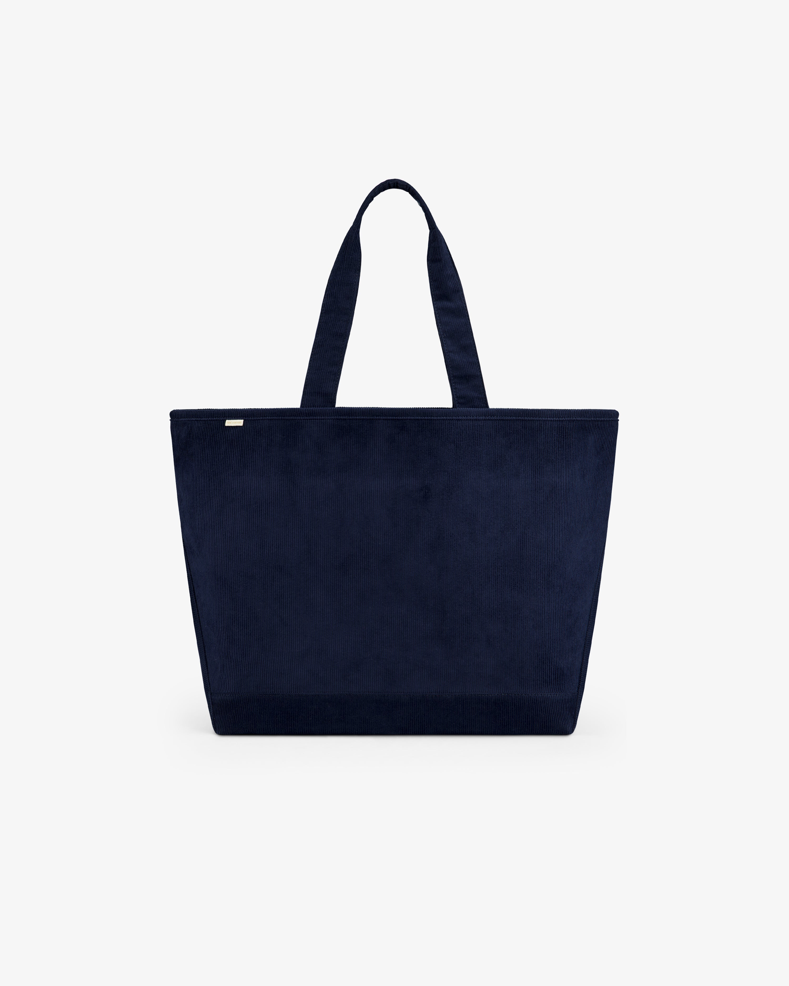Large Corduroy Unisphere Tote Bag in navy blue corduroy with two shoulder straps.