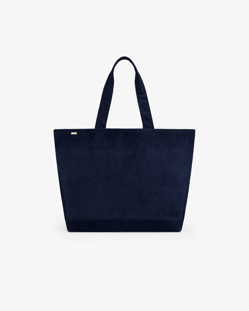 Large Corduroy Unisphere Tote Bag in navy blue corduroy with two shoulder straps.