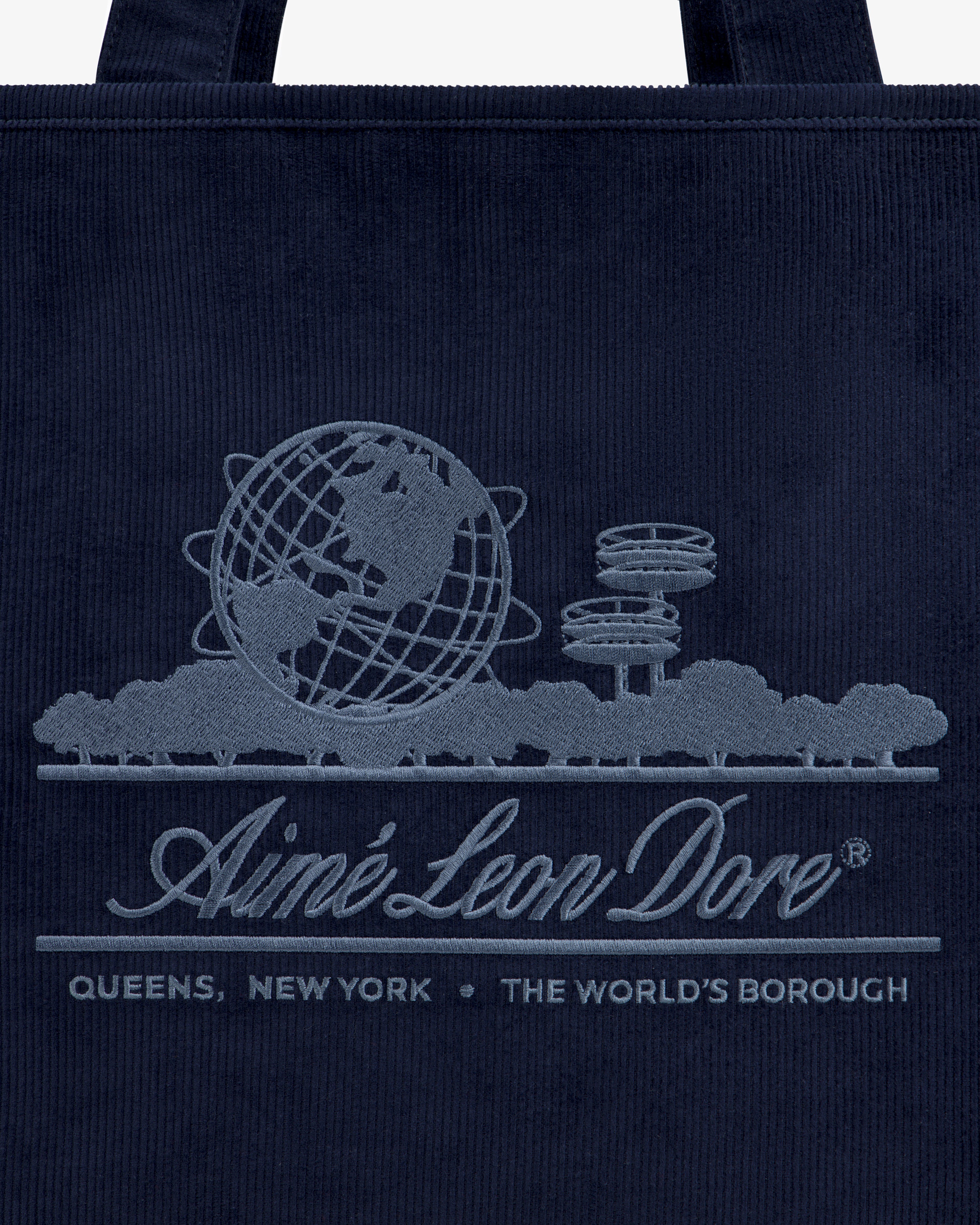 Large Corduroy Unisphere Tote Bag in navy featuring an embroidered Unisphere, trees, and Aimé Leon Dore, Queens, New York.