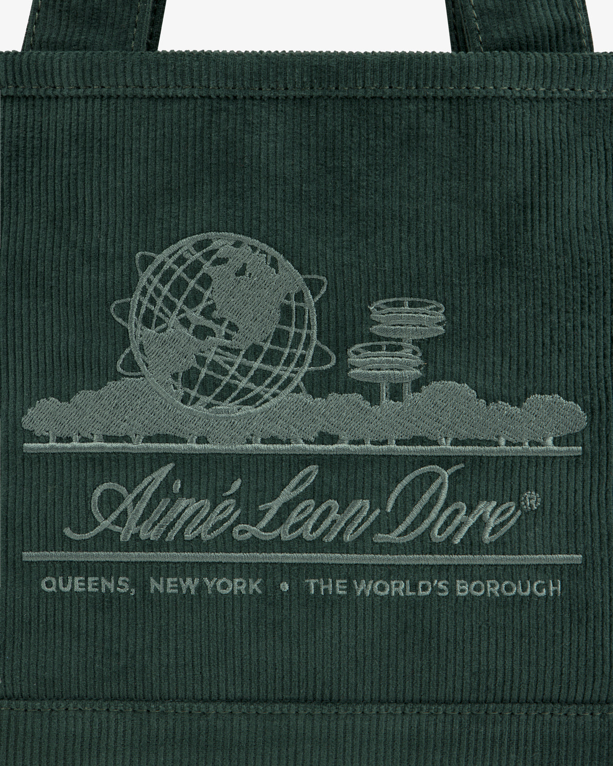 Dark green Mini Corduroy Unisphere Tote Bag featuring an embroidered globe, architectural towers, and Aimé Leon Dore text.