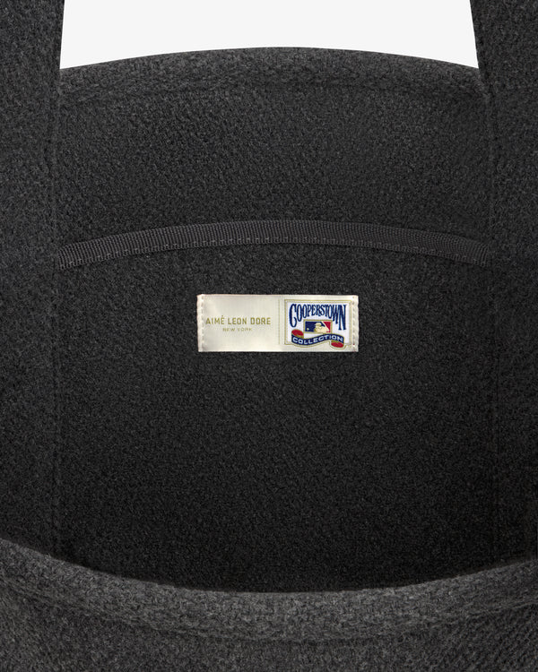 NY Highlanders Wool Tote Bag in dark grey, featuring a label with Aimé Leon Dore and Cooperstown Collection logos.