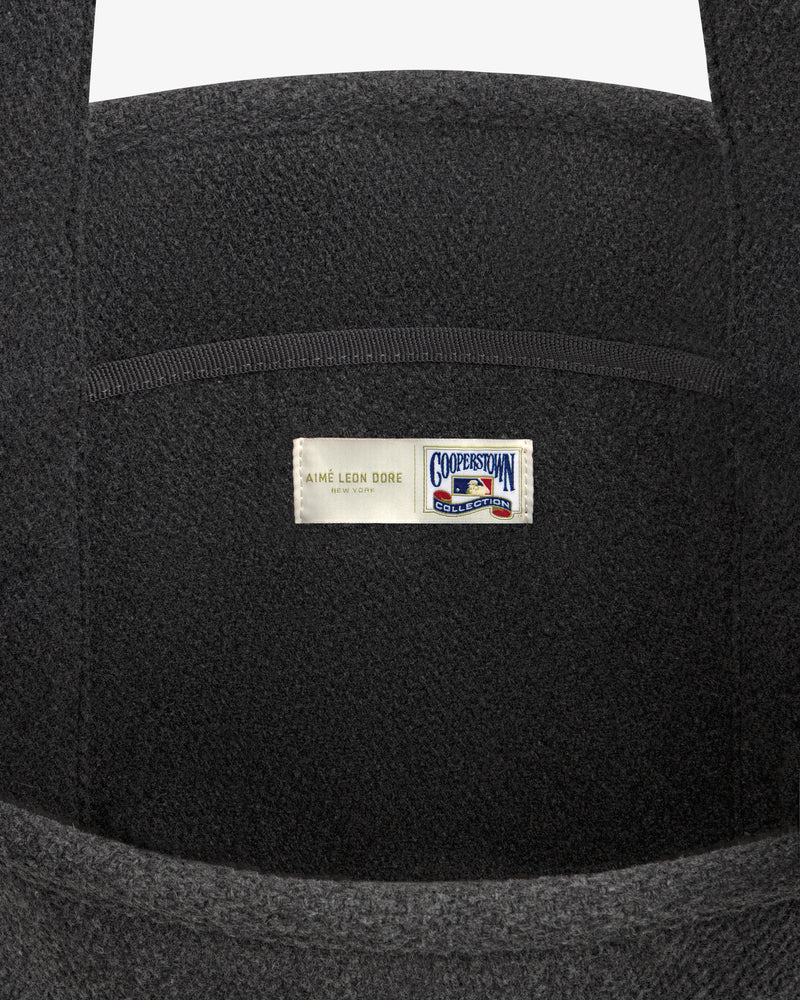 NY Highlanders Wool Tote Bag in dark grey, featuring a label with Aimé Leon Dore and Cooperstown Collection logos.