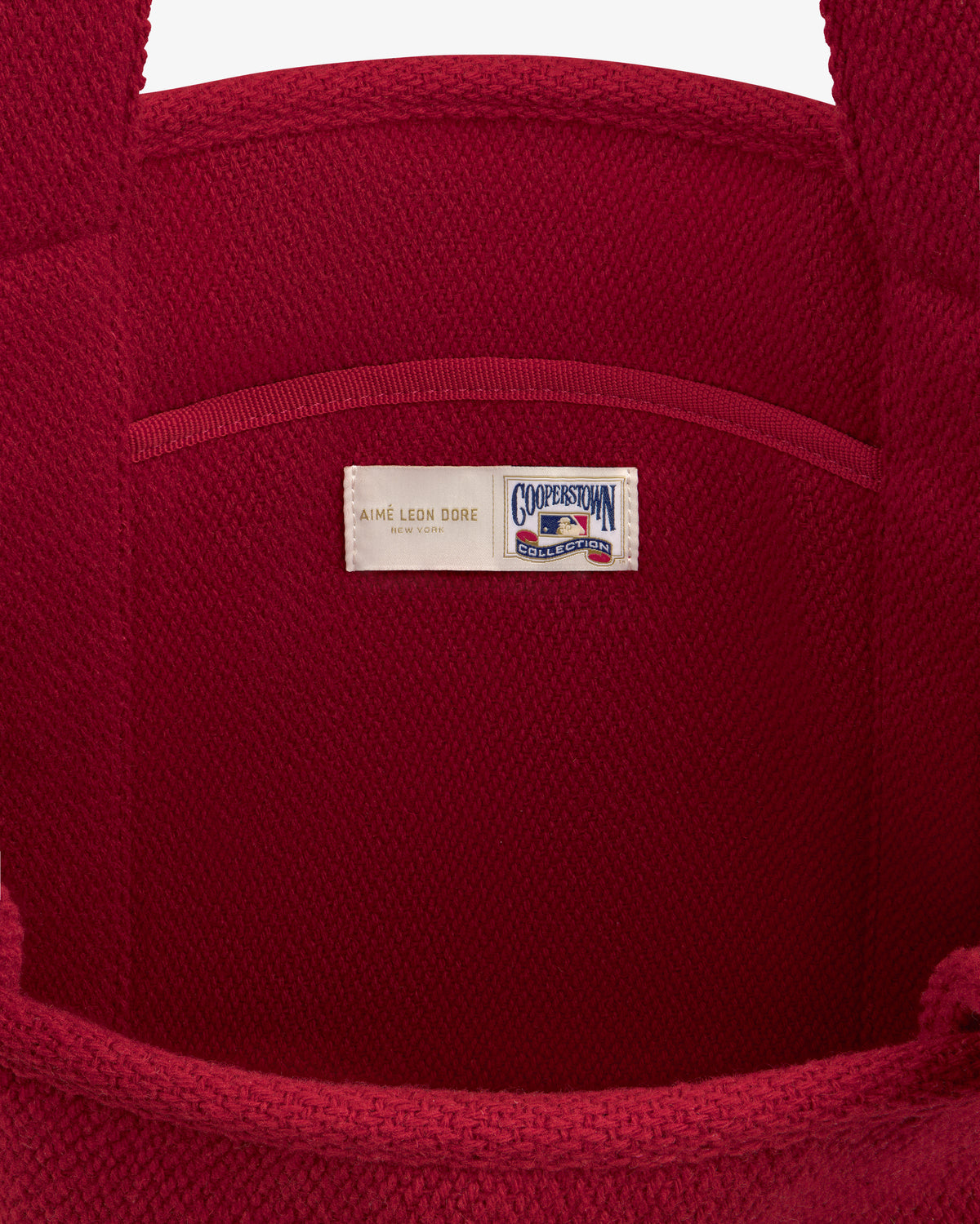 Interior of a red wool NY Highlanders Wool Tote Bag featuring a Cooperstown Collection brand label.