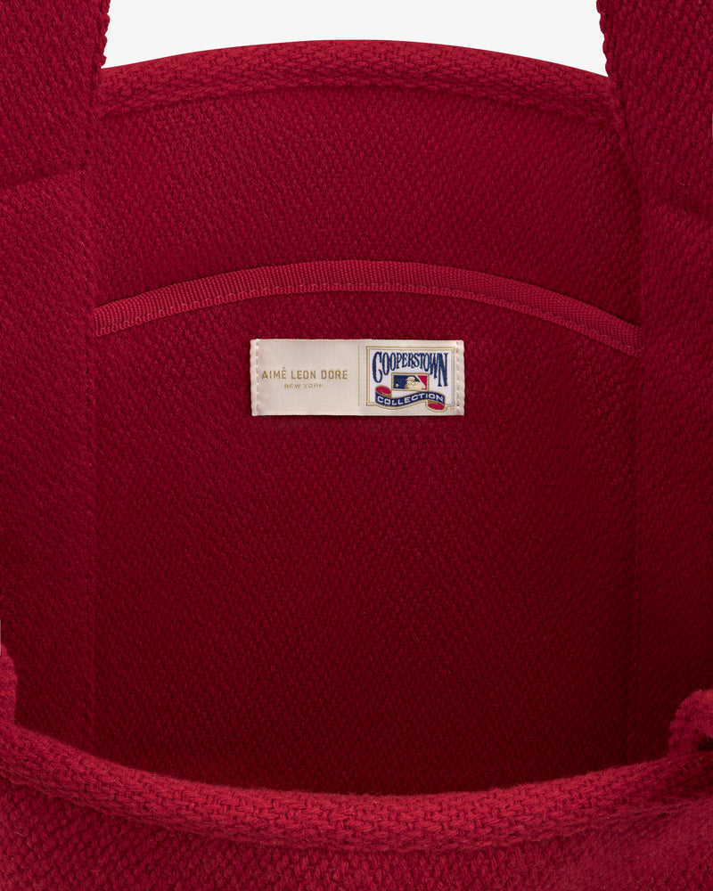 Interior of a red wool NY Highlanders Wool Tote Bag featuring a Cooperstown Collection brand label.