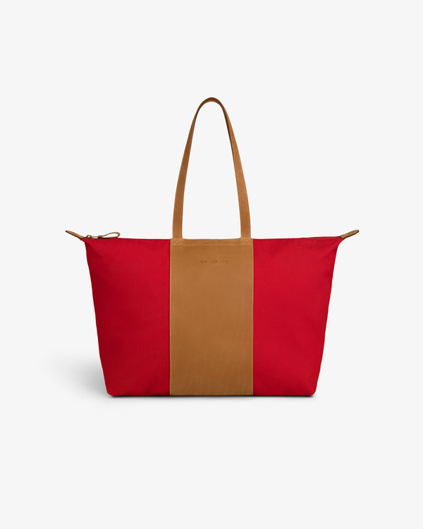 Leather Canvas Zip Tote in red with tan handles and a tan center panel, shown on a plain white background.