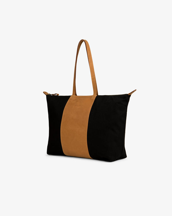 Leather Canvas Zip Tote with brown handles and a vertical stripe, displayed on a plain white background.