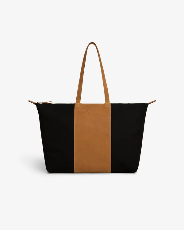 Leather Canvas Zip Tote with black sides, brown center panel and handles on a white background.